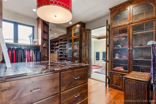 3217 E 61st Pl, Tulsa, OK 74136 - spacious closet featuring wood finished floors