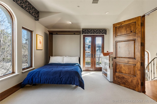 3217 E 61st Pl, Tulsa, OK 74136 - bedroom featuring access to exterior, visible vents, vaulted ceiling, french doors, and light colored carpet