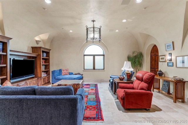 3217 E 61st Pl, Tulsa, OK 74136 - living room featuring stone tile floors, recessed lighting, baseboards, and arched walkways