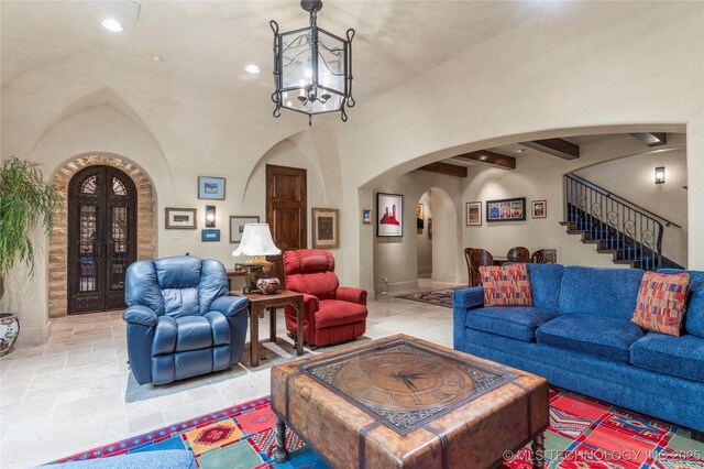 3217 E 61st Pl, Tulsa, OK 74136 - living area with recessed lighting, stone tile flooring, a notable chandelier, stairs, and arched walkways