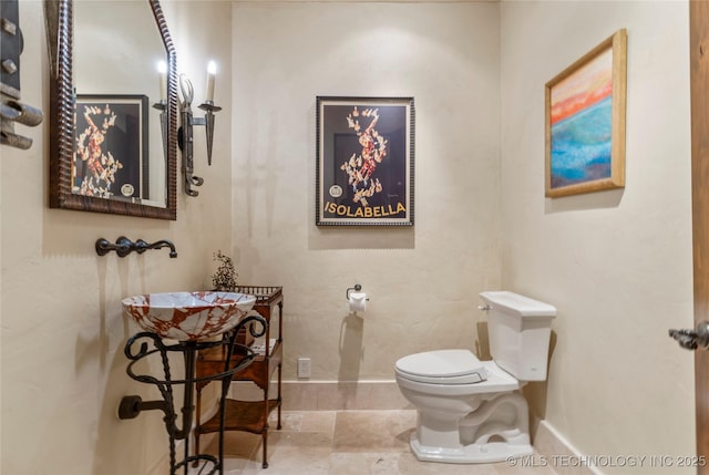 3217 E 61st Pl, Tulsa, OK 74136 - bathroom featuring toilet and baseboards