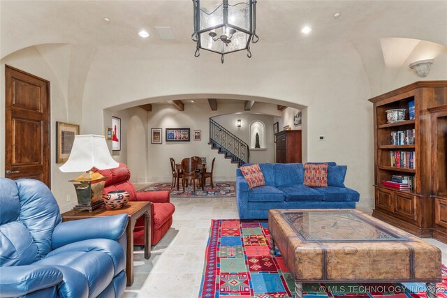 3217 E 61st Pl, Tulsa, OK 74136 - living area featuring stone tile floors, arched walkways, an inviting chandelier, recessed lighting, and stairs