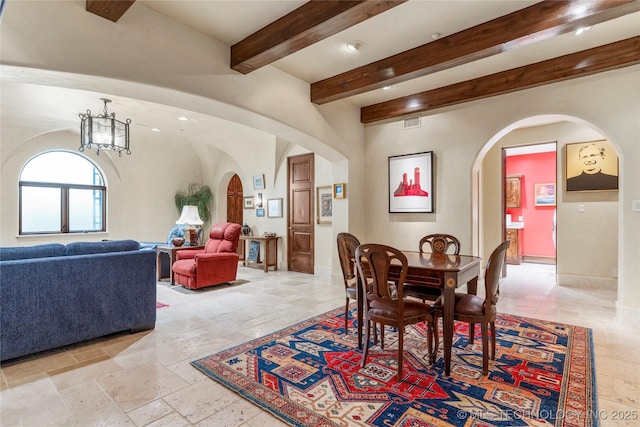 3217 E 61st Pl, Tulsa, OK 74136 - dining space with arched walkways, an inviting chandelier, stone tile floors, visible vents, and beam ceiling
