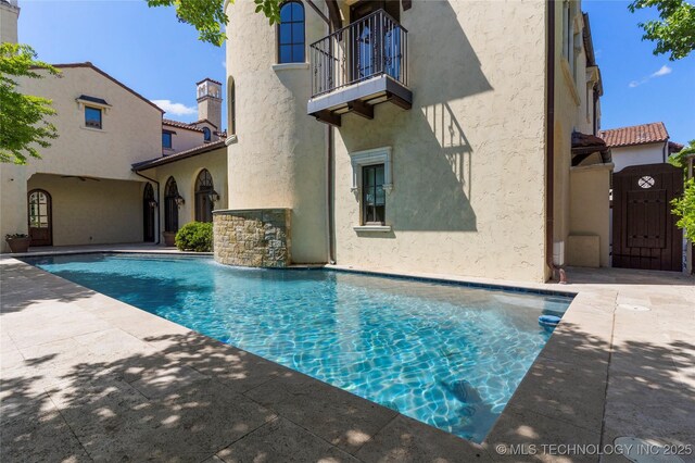 3217 E 61st Pl, Tulsa, OK 74136 - pool with a patio and a gate