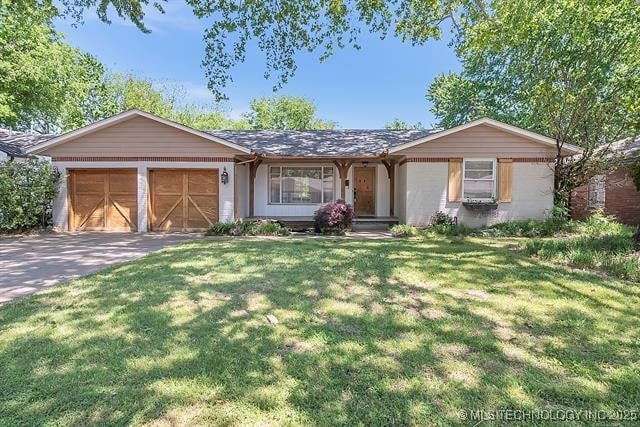4331 S Norfolk Ave, Tulsa, OK 74105 - ranch-style house with an attached garage, concrete driveway, and a front lawn