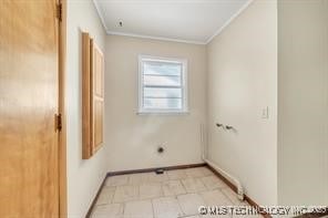 laundry room with laundry area, electric dryer hookup, baseboards, and ornamental molding