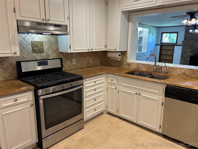 4331 S Norfolk Ave, Tulsa, OK 74105 - kitchen with stainless steel appliances, under cabinet range hood, a sink, a ceiling fan, and white cabinetry