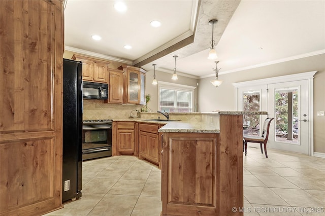 kitchen featuring a wealth of natural light, black appliances, a sink, a peninsula, and light tile patterned floors