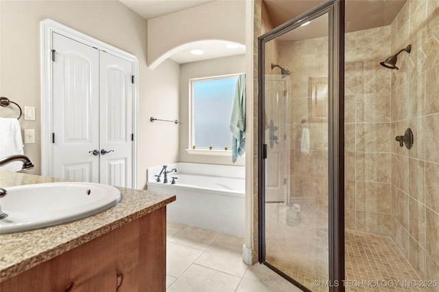 full bath with tile patterned floors, a stall shower, vanity, and a bath