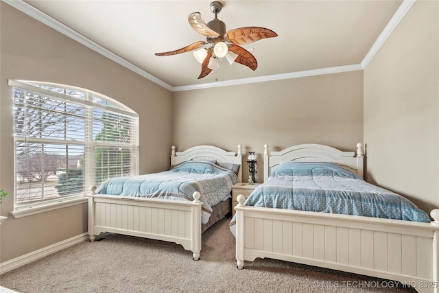 carpeted bedroom with a ceiling fan, baseboards, and ornamental molding