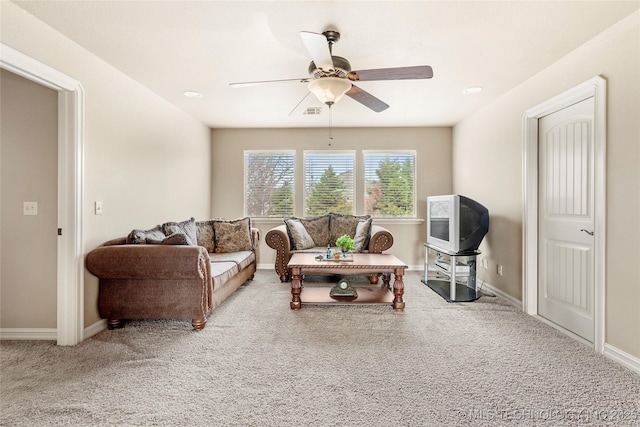 carpeted living area featuring visible vents, a ceiling fan, and baseboards