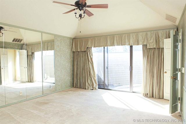 unfurnished bedroom featuring visible vents, carpet, lofted ceiling, and access to outside