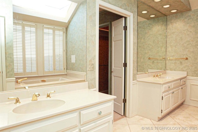 full bathroom featuring wallpapered walls, two vanities, a skylight, tile patterned floors, and a sink