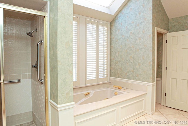 full bathroom featuring a skylight, tile patterned flooring, a shower stall, and wallpapered walls