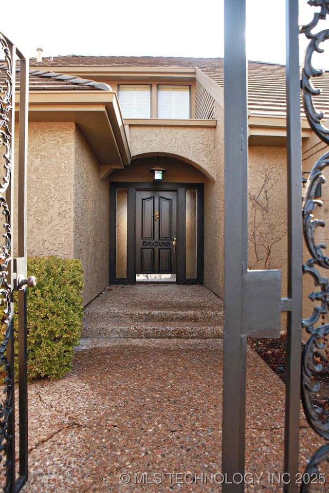 doorway to property with stucco siding