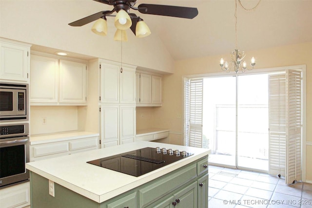 kitchen featuring a kitchen island, green cabinetry, lofted ceiling, stainless steel appliances, and light countertops