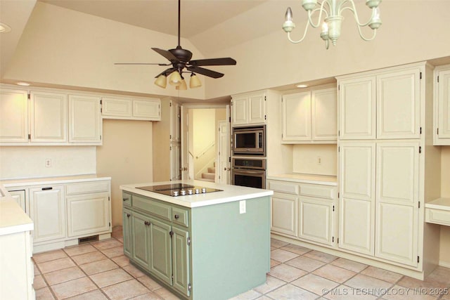 kitchen featuring lofted ceiling, light tile patterned flooring, stainless steel appliances, light countertops, and ceiling fan with notable chandelier