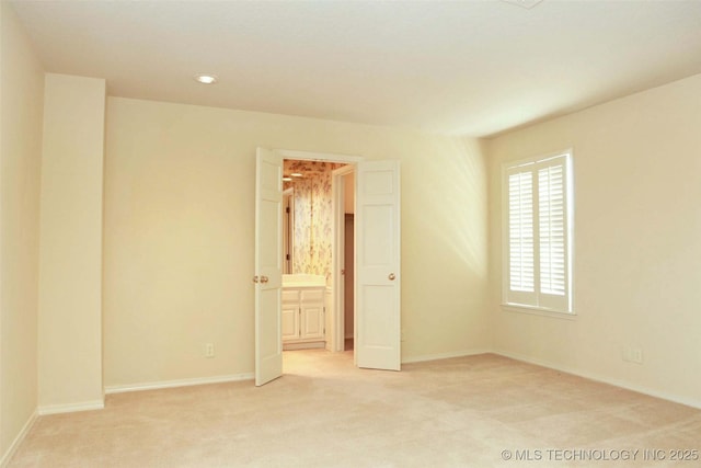 unfurnished room featuring recessed lighting, baseboards, and light colored carpet