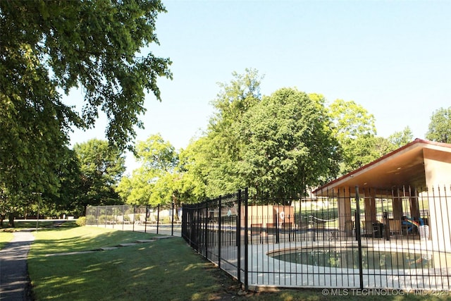 exterior space featuring fence and a lawn