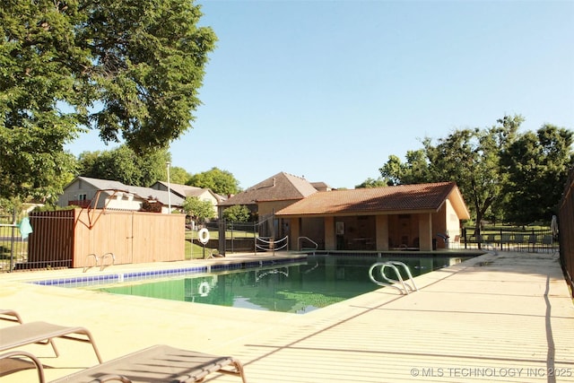 pool featuring a patio and fence