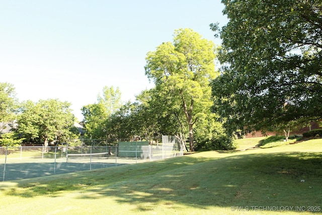 exterior space featuring fence and a lawn