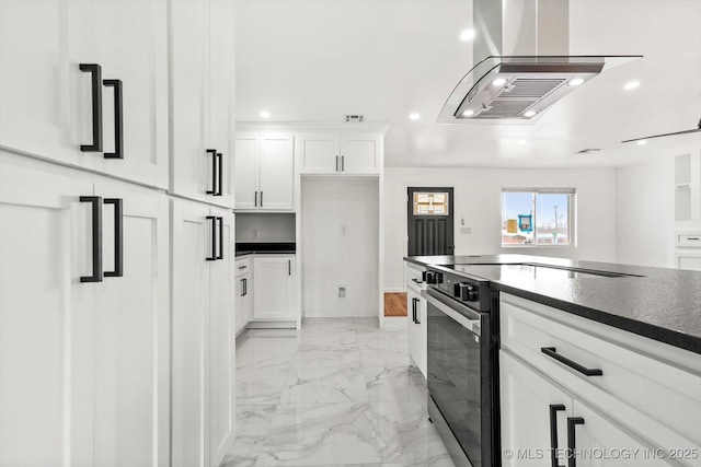 kitchen featuring marble finish floor, dark countertops, electric range oven, exhaust hood, and white cabinets