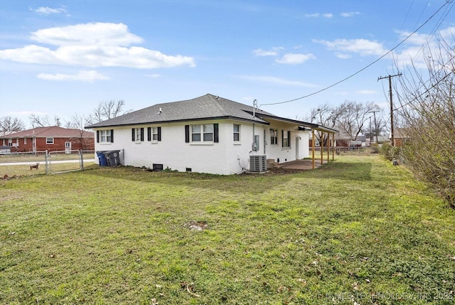 back of house with a patio, a yard, central AC unit, and brick siding