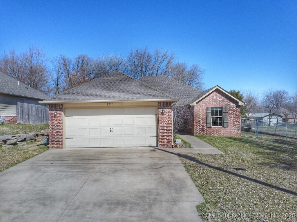 ranch-style house with fence, brick siding, driveway, and a shingled roof