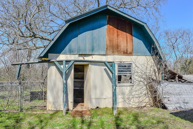 view of barn featuring fence