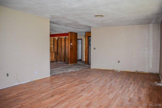 spare room featuring wood finished floors