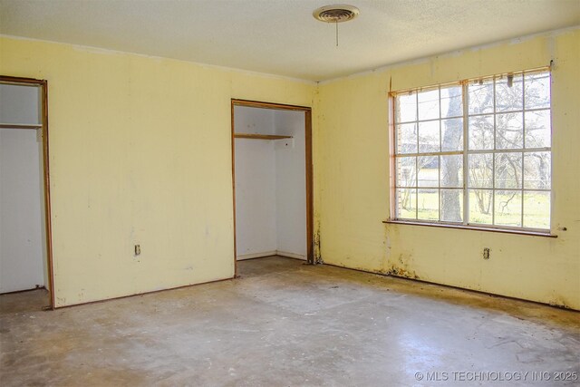 unfurnished bedroom featuring visible vents and unfinished concrete flooring