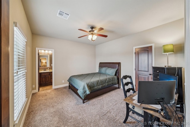 bedroom with baseboards, visible vents, a sink, carpet flooring, and connected bathroom