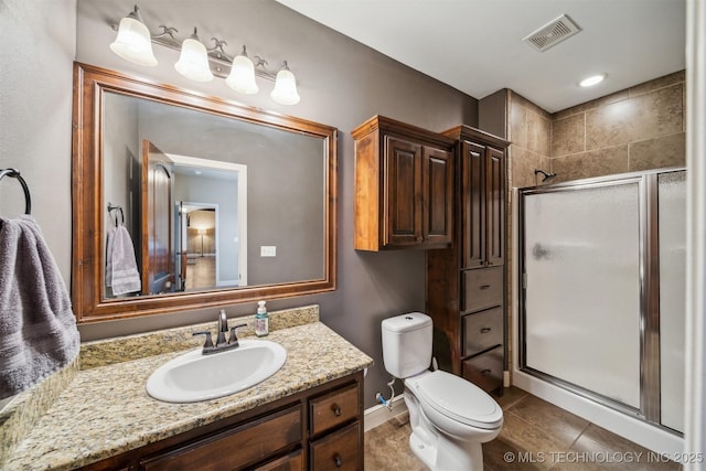 full bathroom featuring visible vents, toilet, a stall shower, tile patterned flooring, and vanity