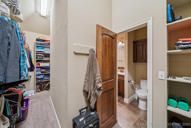 spacious closet with tile patterned floors and a sink