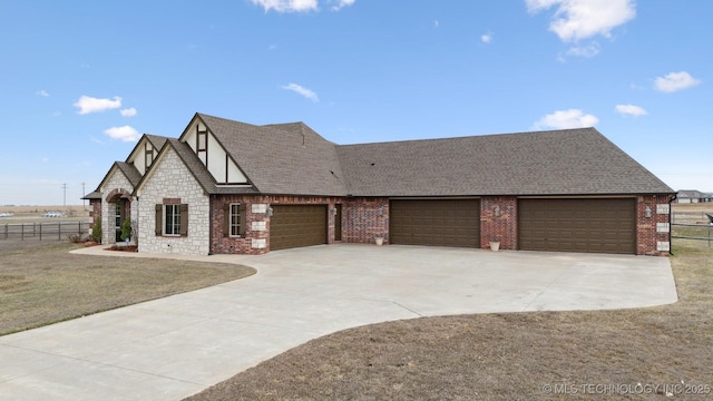 view of front of house featuring fence, driveway, and roof with shingles