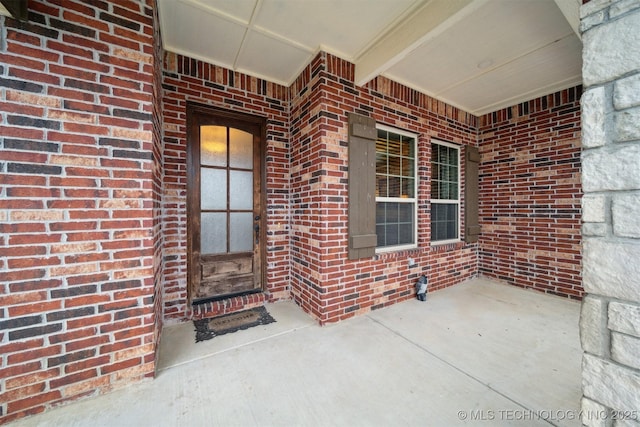 entrance to property with brick siding