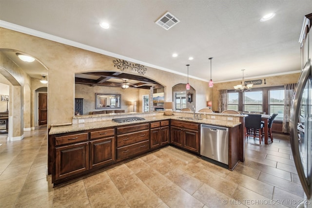 kitchen featuring visible vents, a sink, light stone counters, arched walkways, and dishwasher