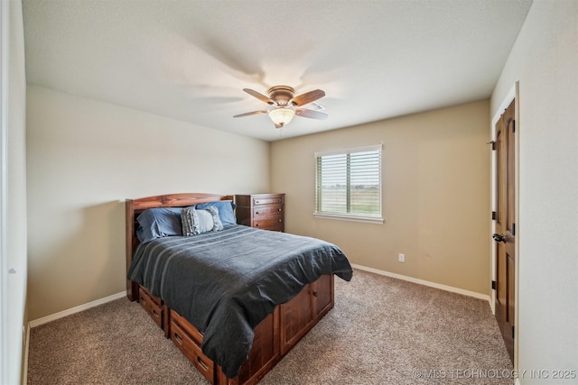 carpeted bedroom featuring baseboards and ceiling fan