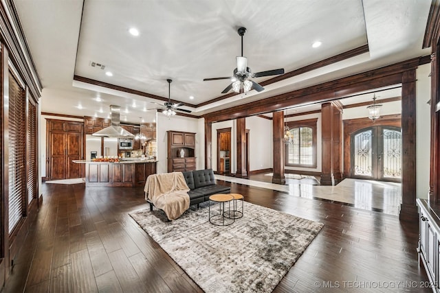 living room featuring dark wood-style floors, visible vents, french doors, and a tray ceiling