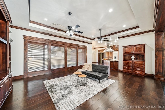 living room with visible vents, ornamental molding, a raised ceiling, and dark wood-style flooring