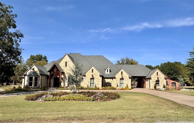 2365 Deer Run, Chouteau, OK 74337 - french country style house featuring stone siding, curved driveway, and a front yard