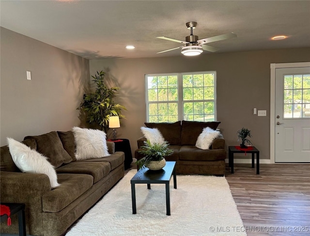 living area featuring recessed lighting, wood finished floors, baseboards, and ceiling fan