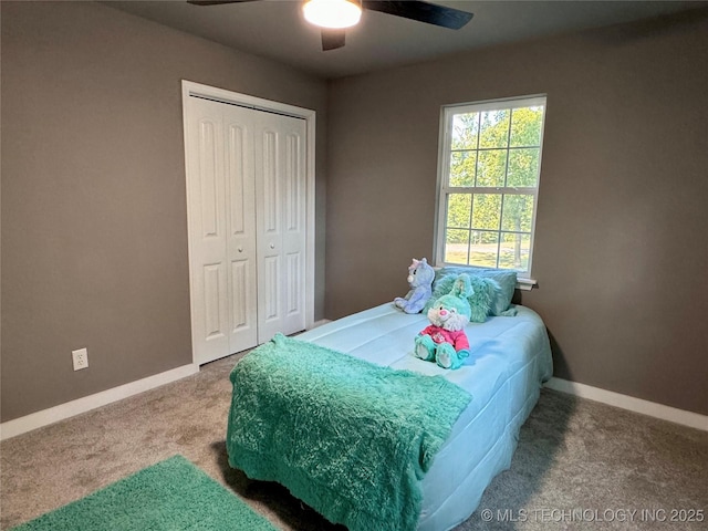 carpeted bedroom featuring a ceiling fan, baseboards, and a closet