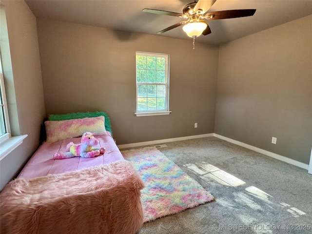 carpeted bedroom featuring a ceiling fan and baseboards