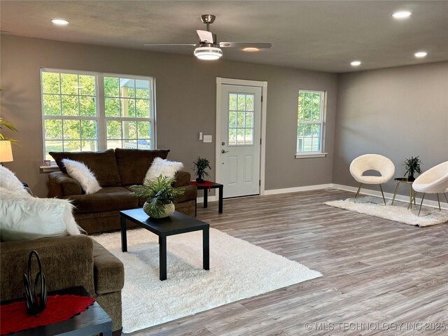 living area with recessed lighting, baseboards, wood finished floors, and ceiling fan