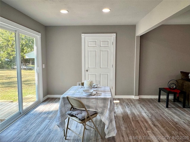 dining room featuring recessed lighting, wood finished floors, and baseboards