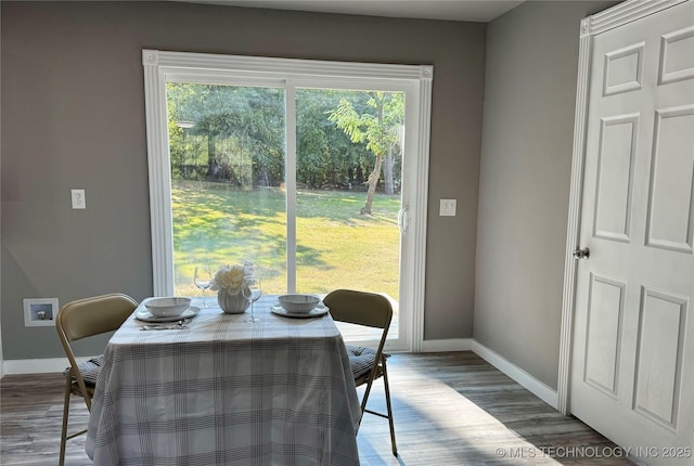 dining room featuring wood finished floors and baseboards