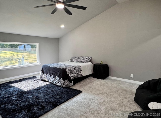 bedroom with lofted ceiling, carpet flooring, baseboards, and ceiling fan