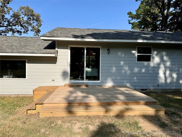 back of house featuring a deck and a shingled roof