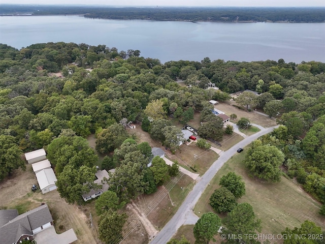 aerial view featuring a wooded view and a water view